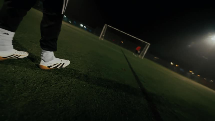 Two people playing soccer outdoors