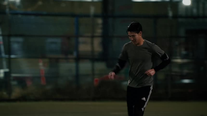 Two men playing soccer out on a field