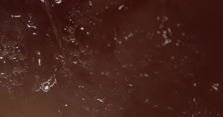 Some liquid being poured into a cup