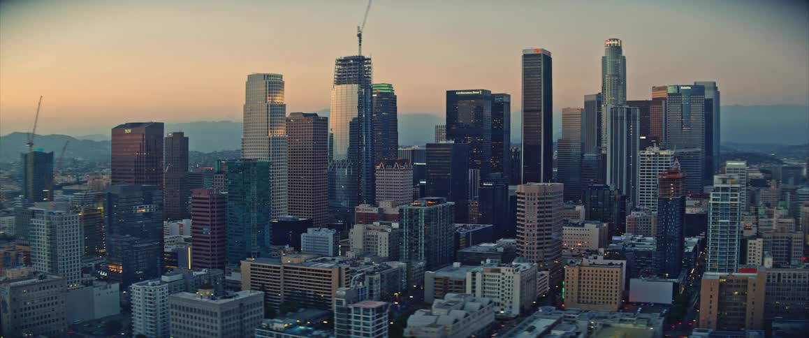 Panorama of modern skyscrapers in a metropolis as day turns to night