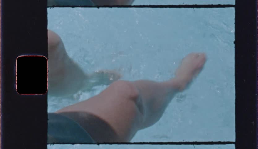 Two persons are waving their foot in a swimming pool