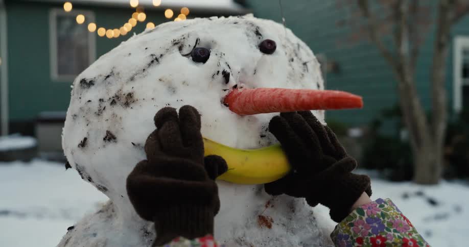 A girl making a snowman