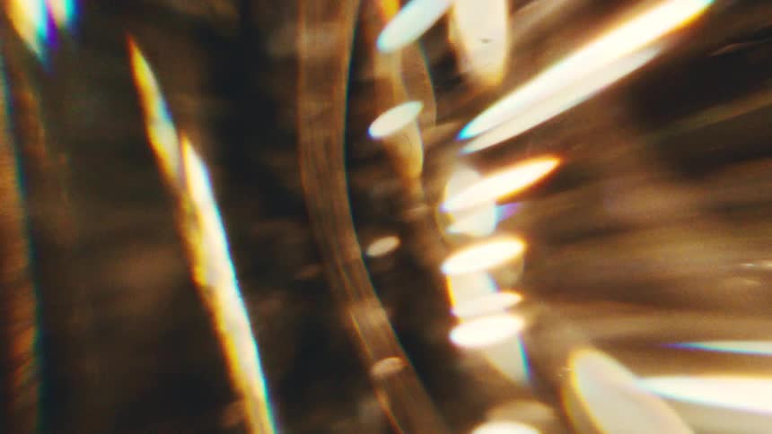 Circular structure with golden reflections and light points in an abstract composition