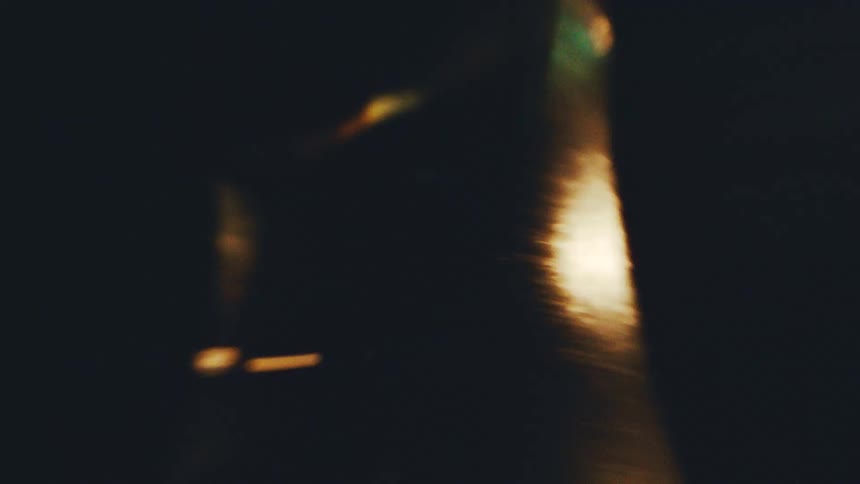 Intense golden light band with bright particles against a dark background