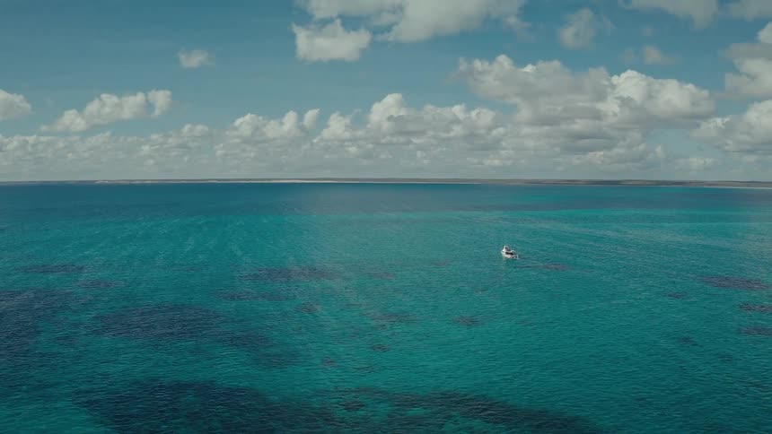 An aerial view of the ocean on a sunny day