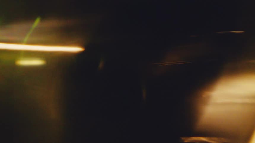 Elongated blurred lights in orange tones over dark background