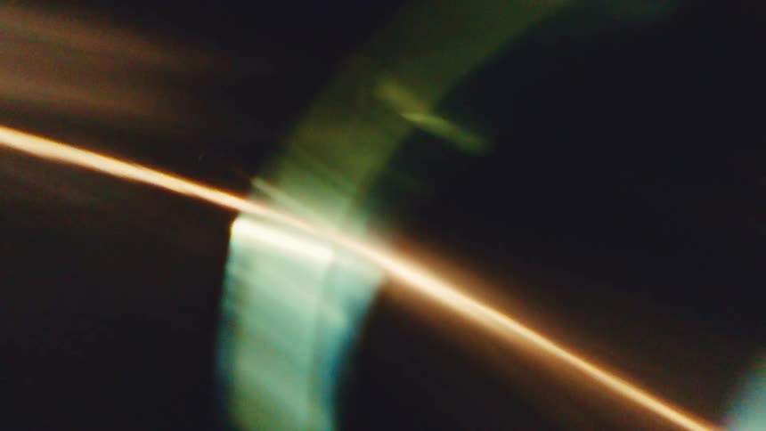 Abstract shapes with blurred lights in shades of yellow and green