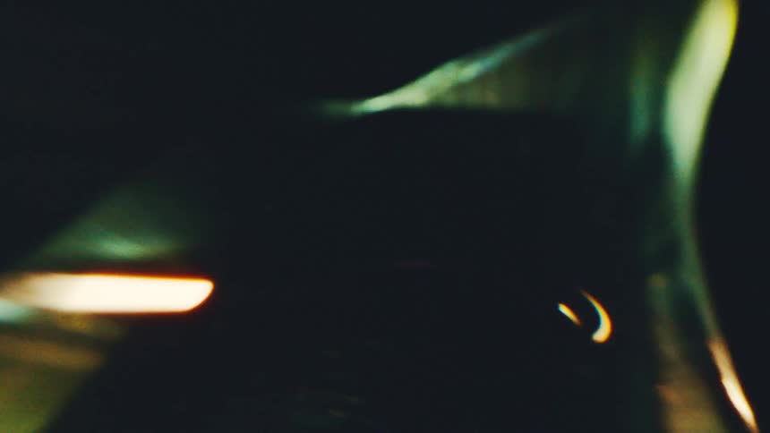 Blurred arcs of light in orange tones over dark background