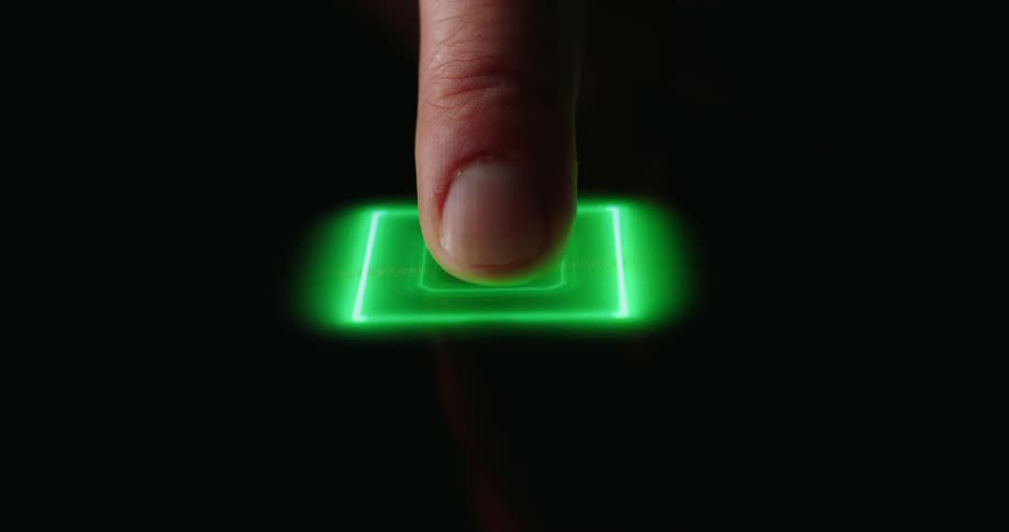 Male human finger pressing a button on a display which activates green led lights shaped like a circuitry indoors