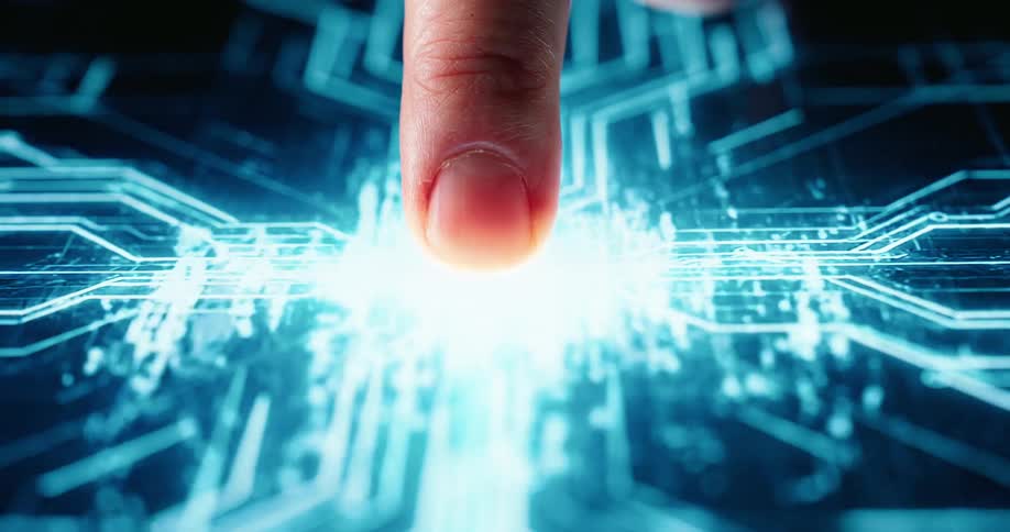 A close view shows a finger pressing a black surface as a bright blue digital interface with circles and circuit lines appears and glows under the touch