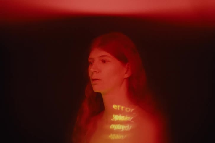 Light projects a message on the womans chest