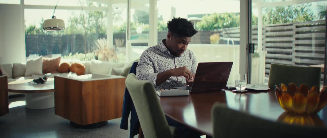 A man using a laptop in a room