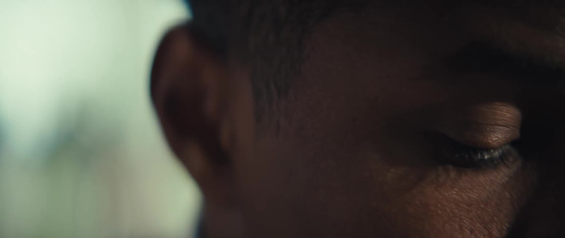 An up close partial look at a black mans face who appears sad