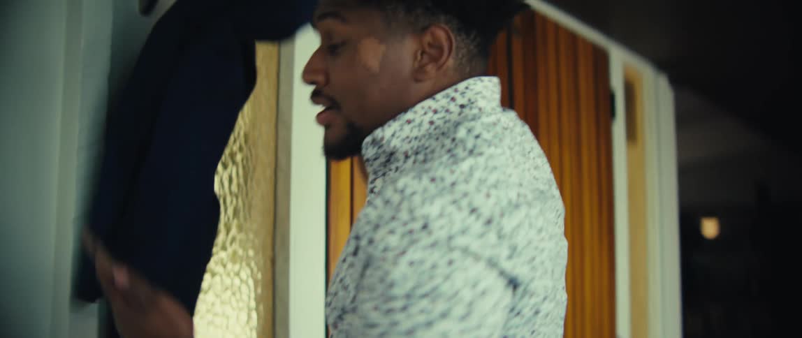 Man using cellphone in front of glass door