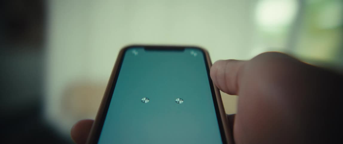 The person spins around while holding his cell phone out