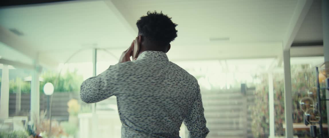 Man talking on a cellphone indoors