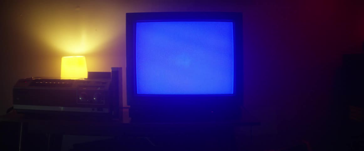Fuzzy picture on lighted screen of a monitor with a lamp in the background