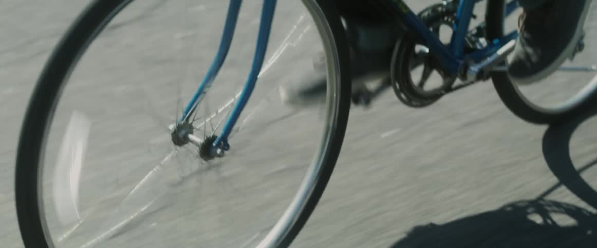A person rides a bike down the road