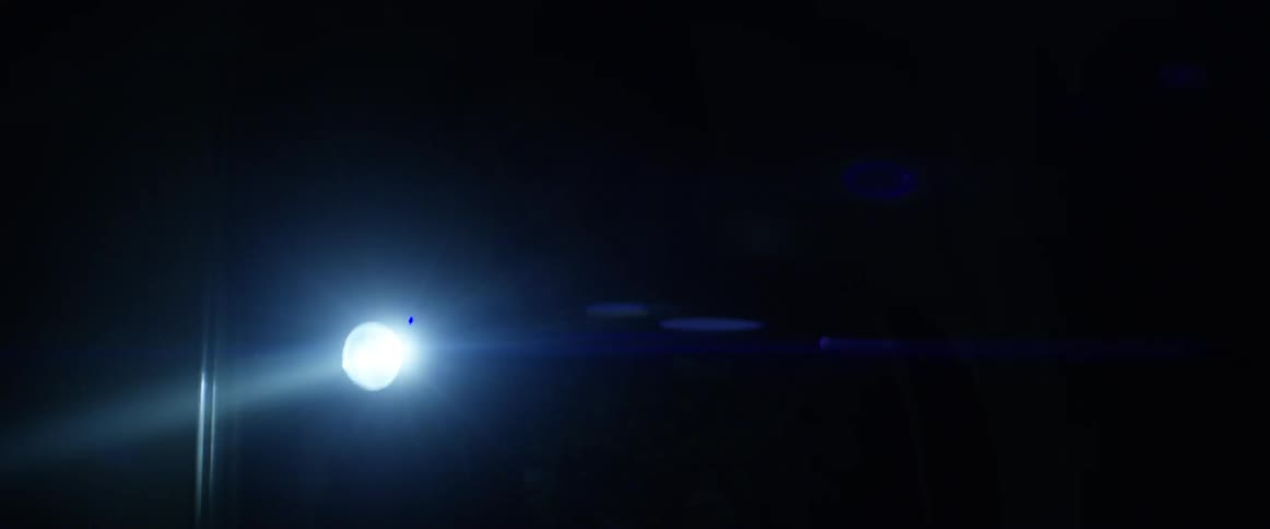 A flashlight shines at night