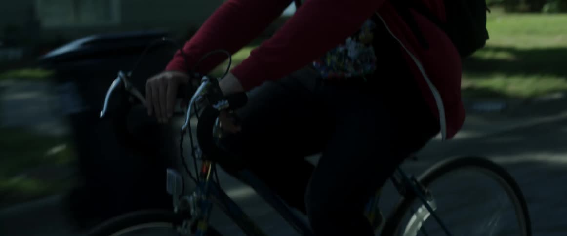 A man rides his bike down the road