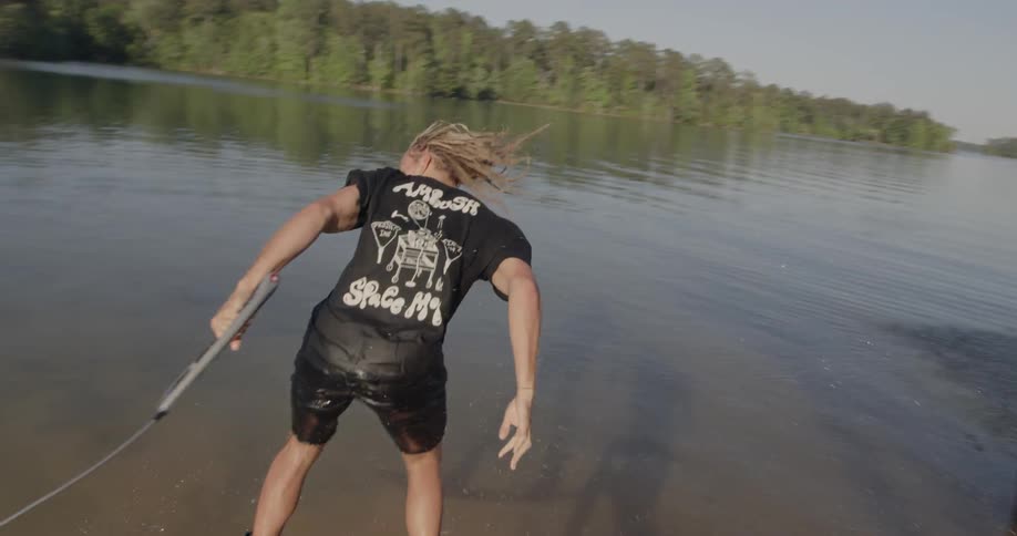 Man wakeboarding jumps over a ramp