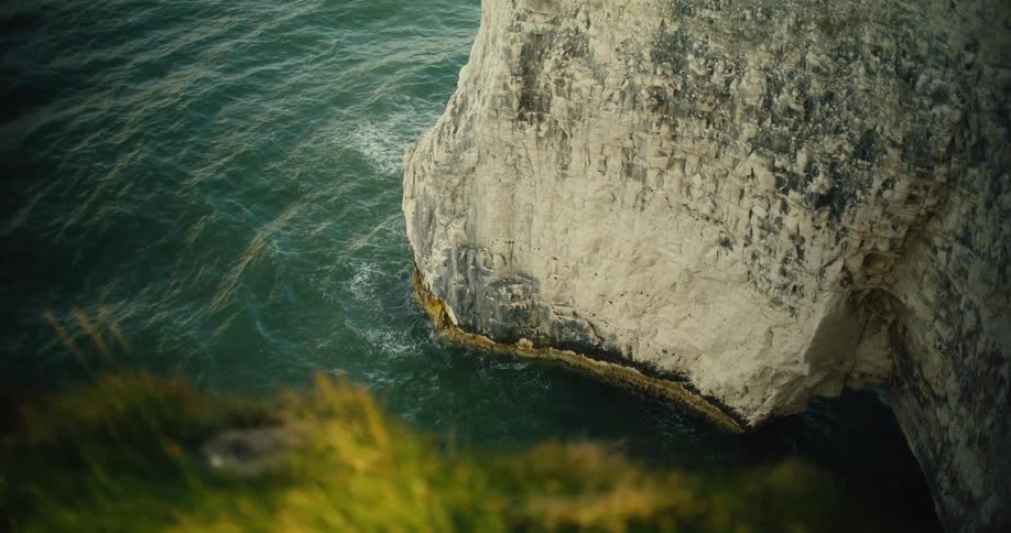 The waves crash against the large rock formations