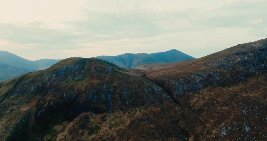 Mountainous landscape aerial view with rocky slopes and vegetation
