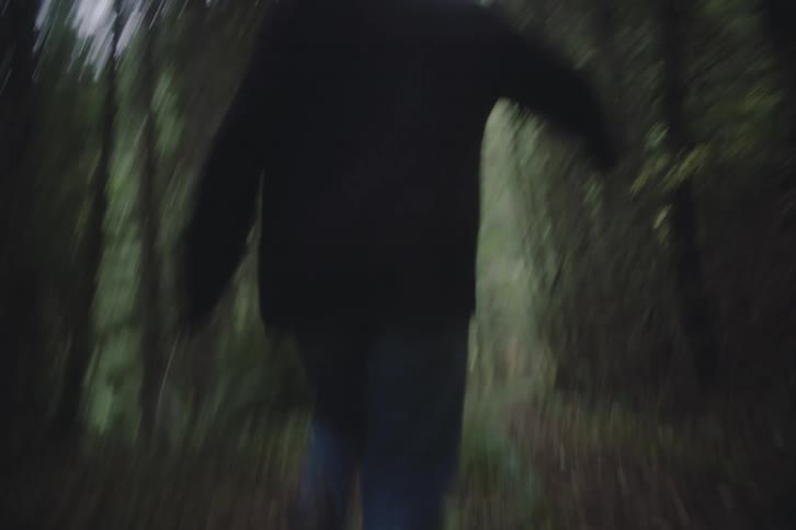 Woman running along a forest trail