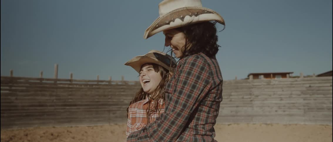Mother and daughter laughing in the corral