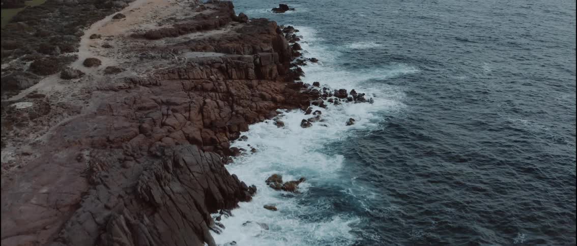 An aerial view of a coast on a cloudy day