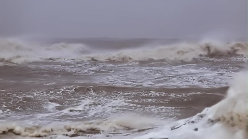 Strong and turbulent waves breaking during a storm at sea