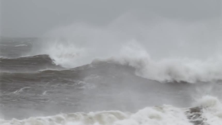 High and rough waves under overcast sky during a storm at sea