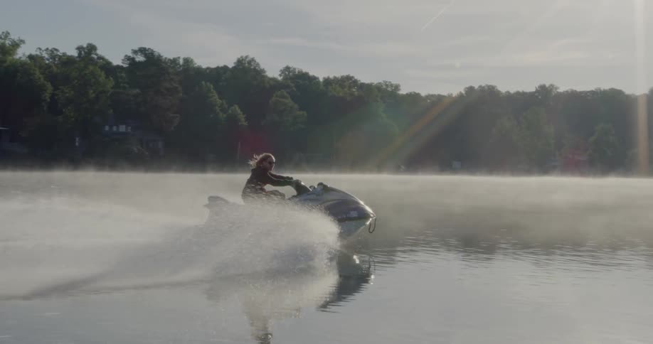 A person rides a jet ski through the water