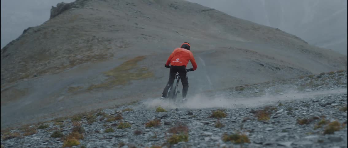 A man riding a bicycle down a mountain