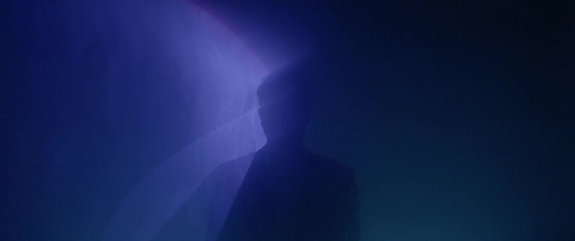 Lights shine behind a man