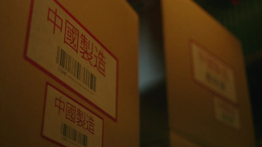 People stack labeled boxes