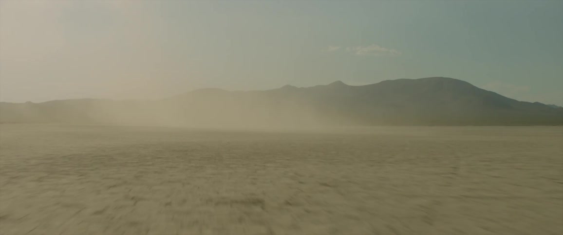 Traveling view of a dusty desert
