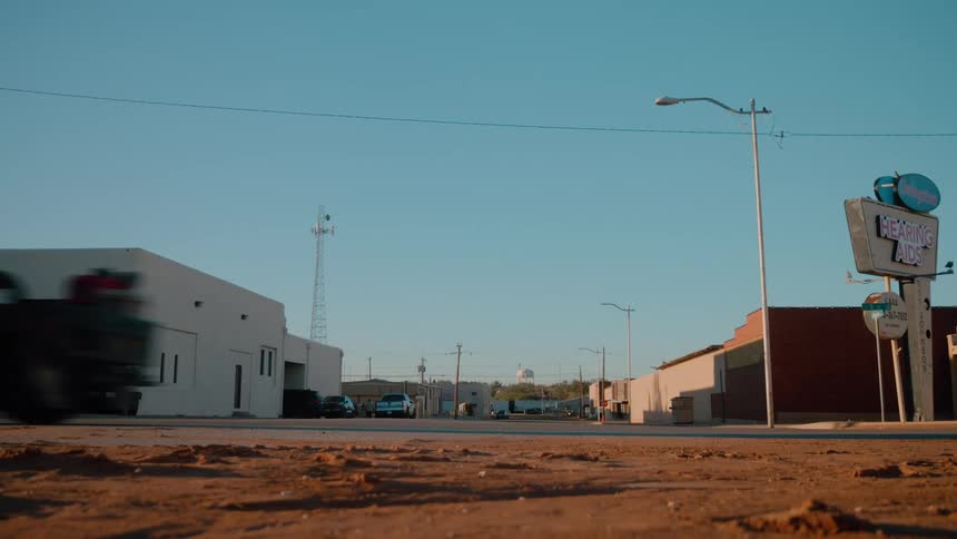 The truck drives on the road through town