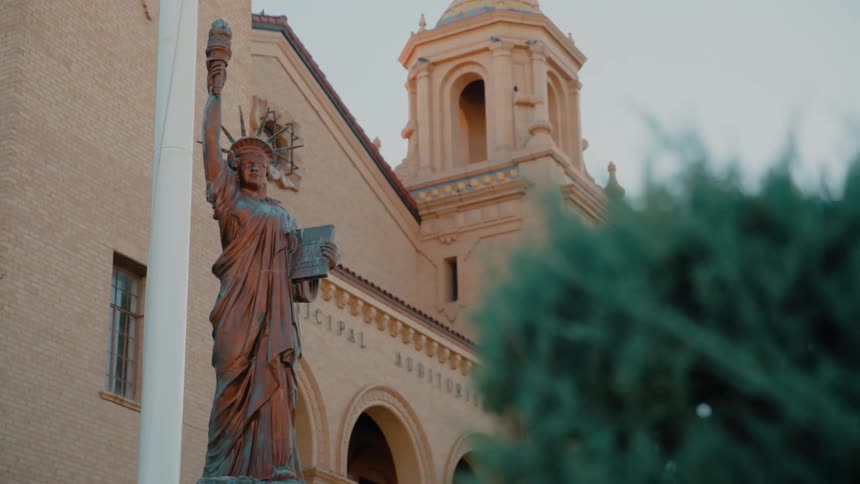 A statue standing out front of a building