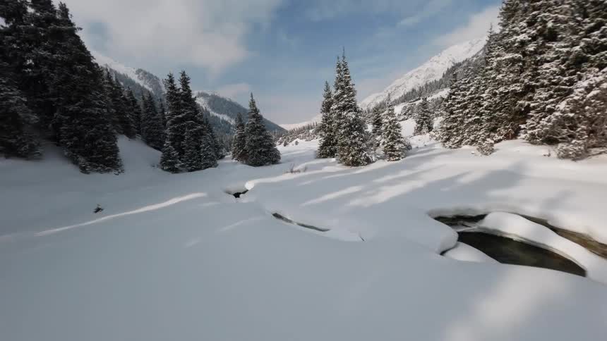 Landscape covered in snow surrounded by mountains outdoors during day time