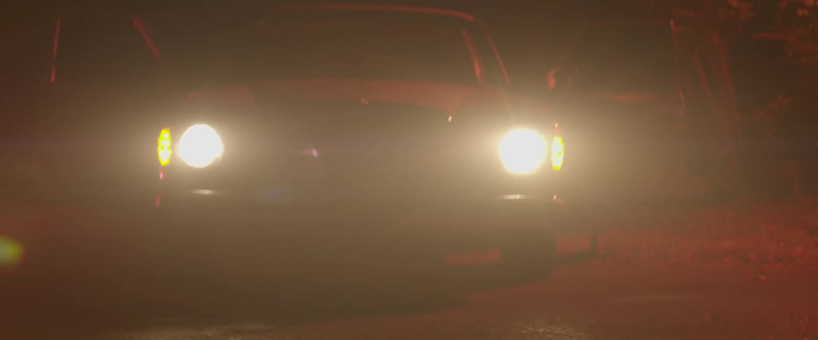 Headlights shine on a car