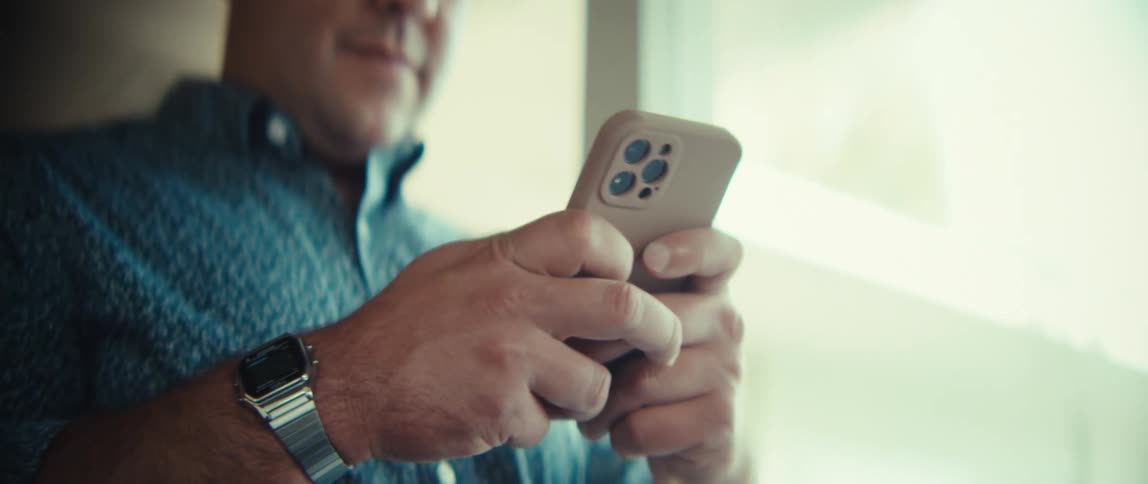 A man using a smartphone in a room