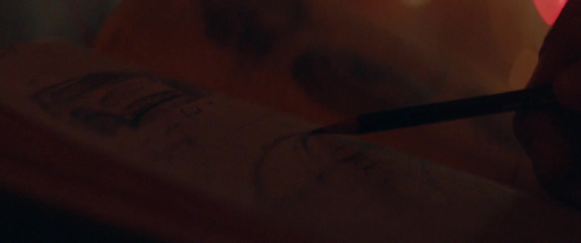 An artist sketches in a notepad