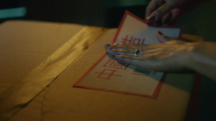 Person puts a label on a box
