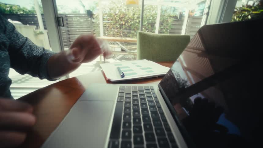 The man opens the laptop and presses a key