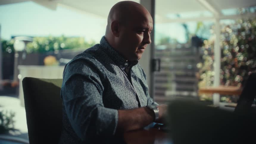 A man using a laptop at a table