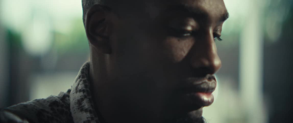 Person with short beard and patterned shirt in side closeup