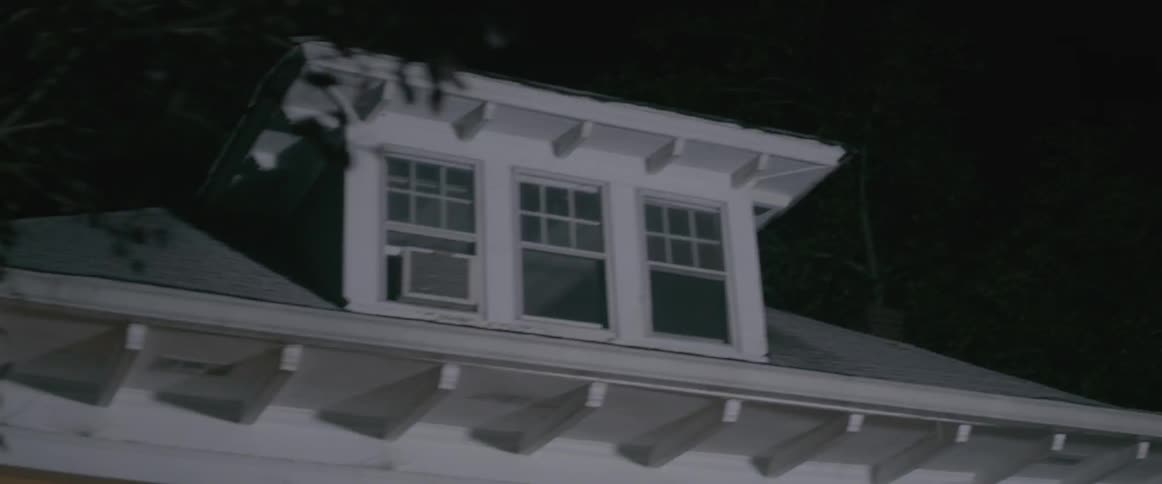 Lights shine on a house at night