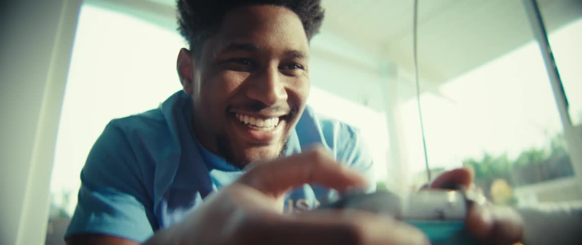Person smiling while playing with video game controller