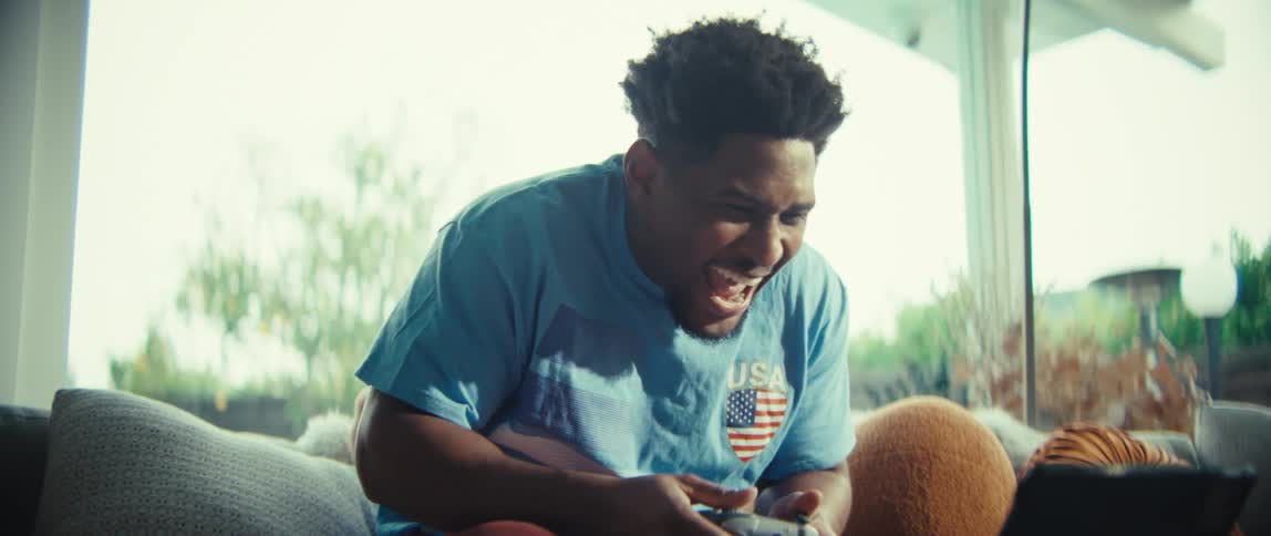 Smiling man playing video games